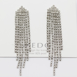 Detailed macro view of long silver tassels with sparkling pavé rhinestones and 925 silver posts