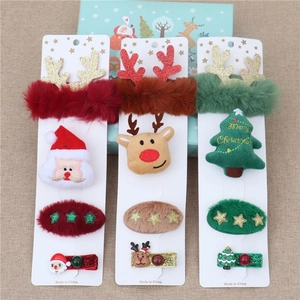 Detailed set of Christmas hair clips featuring Santa, reindeer, and tree plush elements