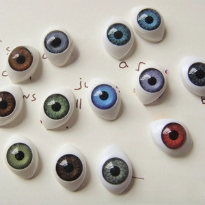 Detailed macro view of 12x16mm acrylic doll eyes in multiple vibrant iris colors