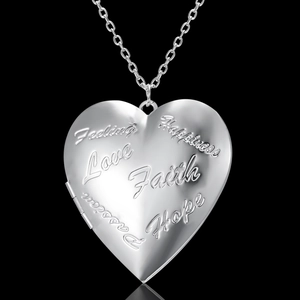 Detail of silver heart locket pendant engraved with Hope Love Faith and Passion words