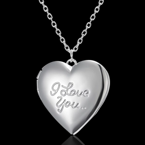 Silver heart locket necklace with I Love You engraving on black background