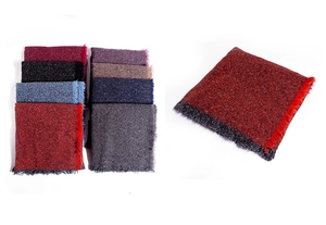 Close-up of thick knitted winter scarf featuring long tassels in various vibrant colors