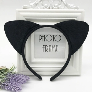 Mysterious black cat ear headband with soft plush fur shown on elegant photo frame
