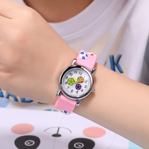 Close-up of pink 3D football relief strap and analog dial on child wrist