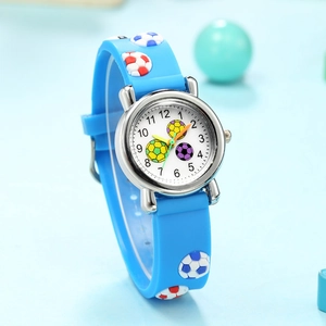 Close-up of children's blue quartz watch featuring 3D soccer relief patterns on the strap