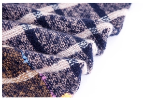 Macro shot of knitted bouclé plaid fabric in navy and khaki with soft woven texture