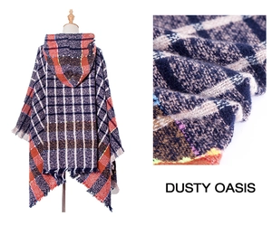 Macro shot of knit plaid texture and tassel hem on a multicolor hooded cape shawl