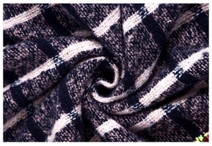 Macro shot of soft knit boucle yarn plaid fabric in navy blue and taupe tones