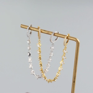 Detail of luxury S925 sterling silver tassel earrings with crystal fringe in gold and silver