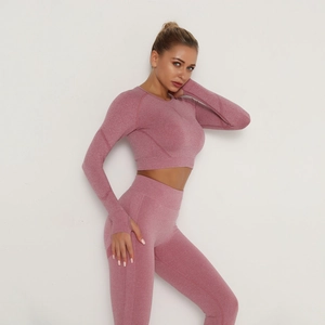 Detail of seamless dusty pink yoga set showing high waist leggings and thumbhole sleeves