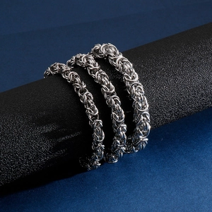 Polished silver stainless steel braided chain bracelet for men in interlocking design