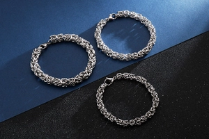 Detailed view of silver stainless steel Byzantine chain bracelets with lobster clasps