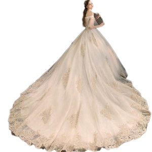 Luxurious ivory white off-shoulder wedding dress with gold lace embroidery and long train