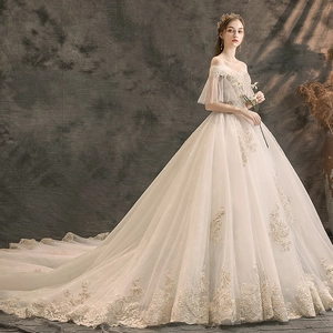 Luxurious off-shoulder ivory wedding dress with elegant embroidery and long royal train