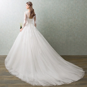 Elegant white lace wedding dress with long sleeves, corset back and long train