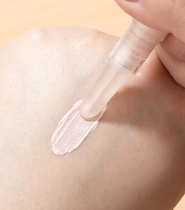 Detailed macro view showing the smooth application of light pink fluid from a twist pen