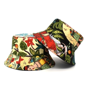 Detail view of cotton bucket hats with Frida Kahlo inspired floral and parrot prints