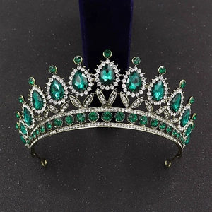 Detail shot of vintage baroque bridal crown with emerald green teardrop crystals