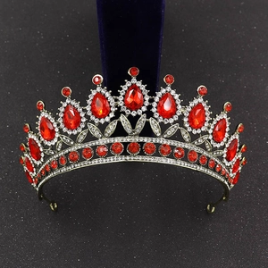 Macro detail of Baroque bridal crown with red teardrop gems and crystal rhinestones