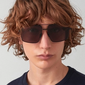 Fashionable double-bridge irregular metal sunglasses with black lenses on female model