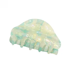 Detailed view of large marble green acrylic hair claw clip with pearl texture