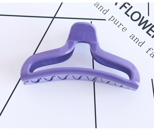 Detailed close-up of a large purple hair claw clip with MJ-650 engraving and non-slip teeth