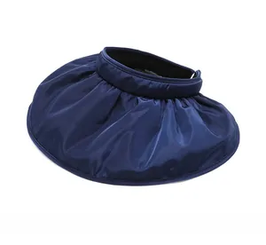 Detail view showing navy blue shell hat with pleated brim and silk-like glossy fabric