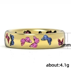5mm gold ring with pink and blue zircon butterflies, weighing 4.1g on white background