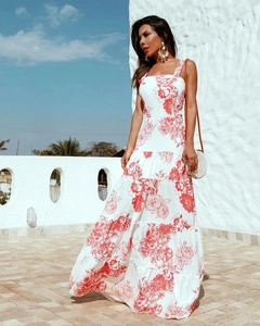 Detail view of the tiered maxi dress featuring red and white floral prints and wide straps