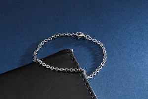 Close-up of minimalist silver stainless steel link chain with a secure lobster clasp