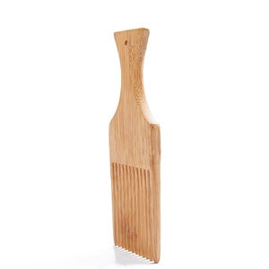 Detailed view of natural bamboo curved beard comb with unique wood grain texture