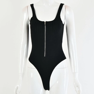 Close-up detail of black ribbed bodysuit with low-cut zipper front on white mannequin