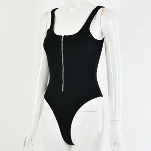 Detail of black ribbed knit bodysuit featuring a functional silver front zipper closure