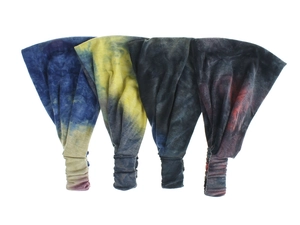 Detail of four tie-dye yoga headbands with ruched elastic design in various colors