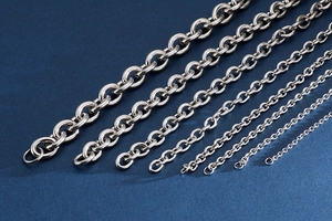 Detailed macro view showing various sizes of silver stainless steel link chains