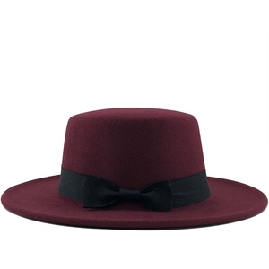 Elegant wine red wool felt boater hat with a flat top and black ribbon bow detail