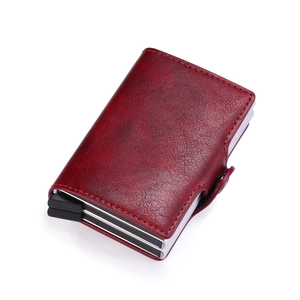 Macro detail of wine red PU leather wallet with aluminum automatic pop-up card mechanism