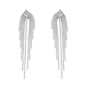 Close-up of silver tassel earrings with delicate hanging chains and sparkling zircon