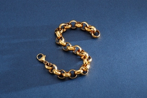 Detail of a gold stainless steel link chain bracelet with a secure lobster clasp closure