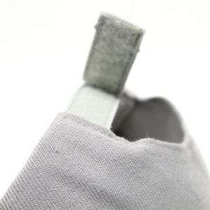 Detailed macro view of light gray fabric cap with hook-and-loop fastener strap