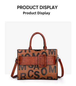 Detail view of retro brown faux leather handbag with black letter print and square buckle