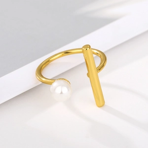 Detailed close-up of a 18k gold plated open ring with a white pearl and geometric bar