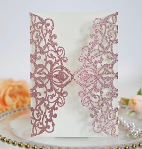 Detailed laser cut rose gold glitter invitation cover with elegant floral patterns
