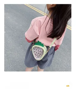 Detail of strawberry-shaped sequins crossbody bag with adjustable long shoulder strap