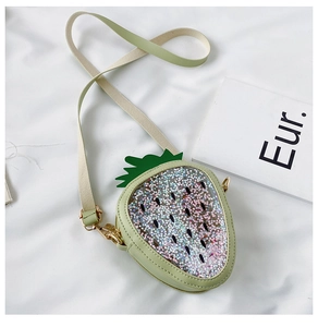 Detail of light green strawberry-shaped bag with sparkling colorful star sequins