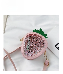 Close-up of pink strawberry girl bag with sequin star shaker and gold metal buckle