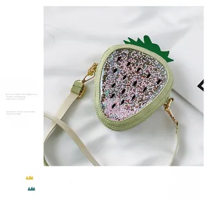 Detail view of strawberry-shaped sequin crossbody bag with transparent star filling