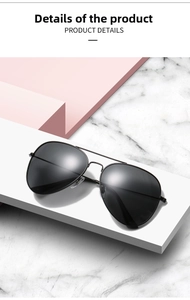 Detailed close-up of polarized aviator sunglasses with black metal frame and double bridge
