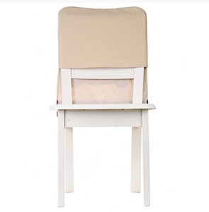 Detail of beige linen chair cover for Christmas on a white wooden chair back
