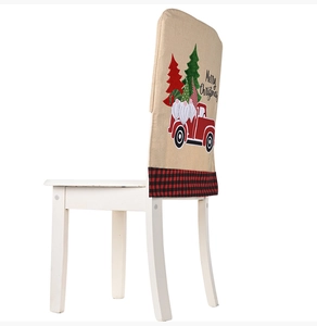 Detail of linen Christmas chair cover with gnome, truck design and Merry Christmas text